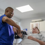 A nurse takes a patient's blood pressure