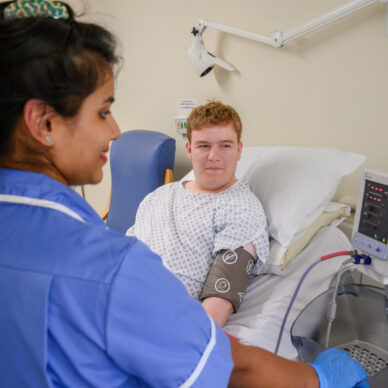 A nurse takes a patient's blood pressure