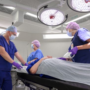 Surgeons and an anaesthetist with a patient in theatre