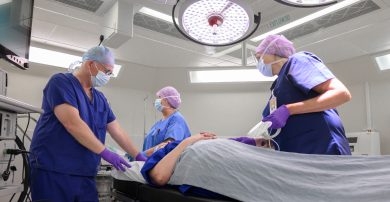 Surgeons and an anaesthetist with a patient in theatre