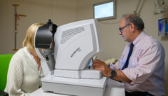 A consultant tests a patient's vision
