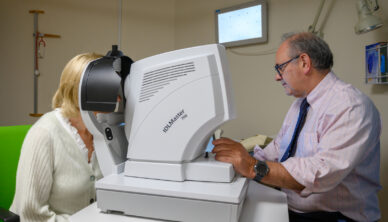 A consultant tests a patient's vision