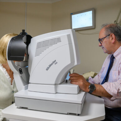 A consultant tests a patient's vision
