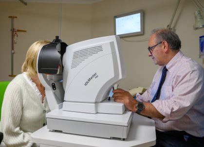 A consultant tests a patient's vision