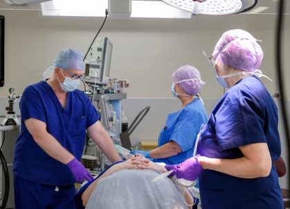 Surgeons treating a patient in theatre