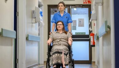 Nurse assisting patient in wheelchair