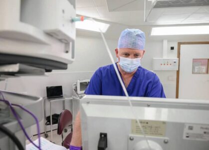 Consultant studying patient data on screen